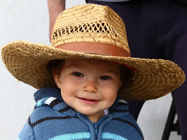 Photo shop in Belgrade: a print of a smiling boy in a straw hat, made at Foto Jocković